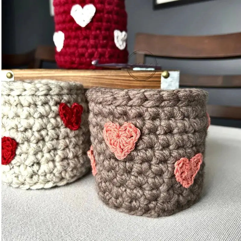 The finished baskets, made from this crochet kit, are sitting on a table.