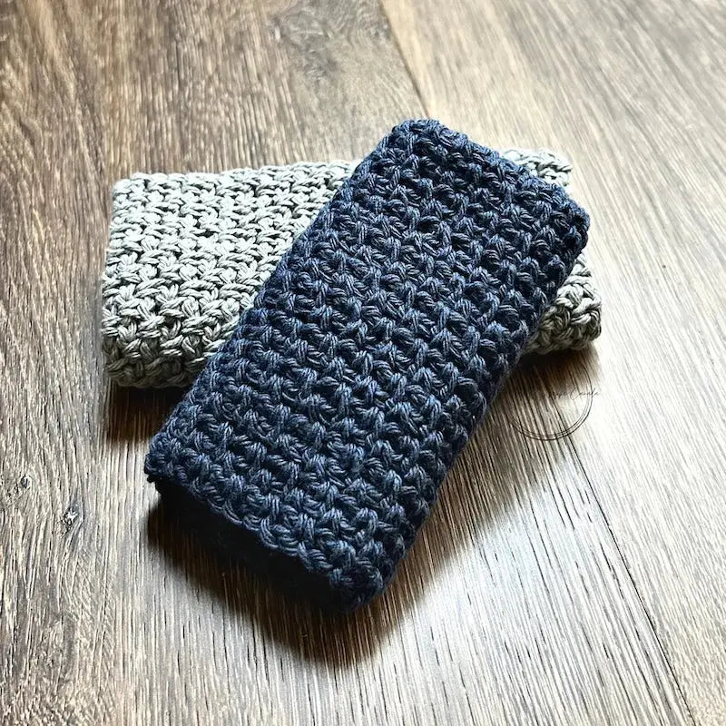 The finished washcloths, made from this crochet pattern, are sitting on the floor.