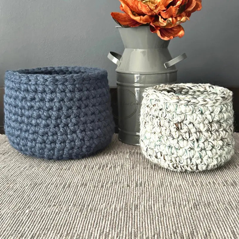 The finished baskets, made from the crochet pattern are sitting on a table.