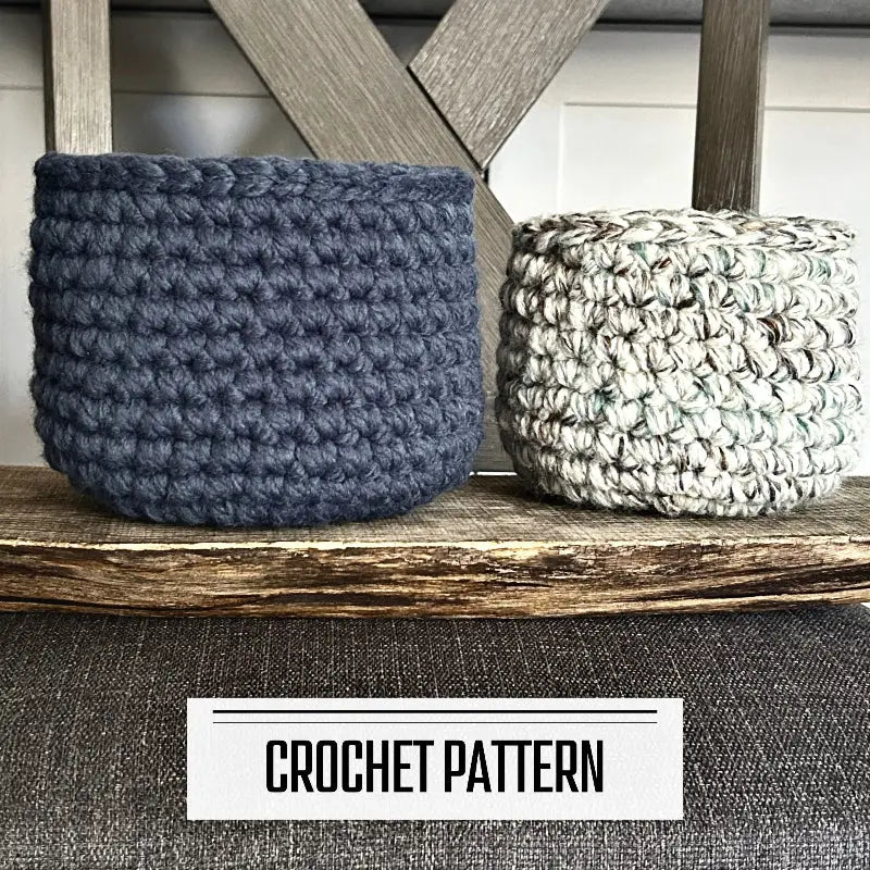 A digital PDF crochet pattern for a set of 2 storage baskets. The baskets are sitting on top of a wooden board.