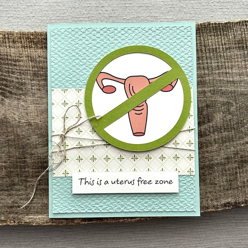 A finished card, from this card making kit, sitting on a wooden board.