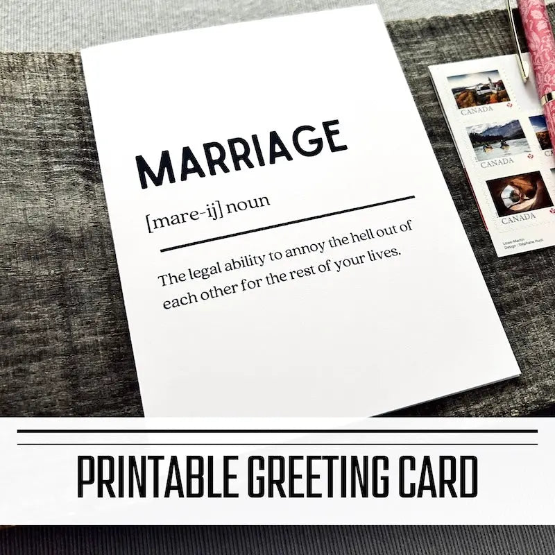 A printable greeting card for a wedding, anniversary or Valentine's Day. The finished card is sitting on a wooden board with a pen and stamps.