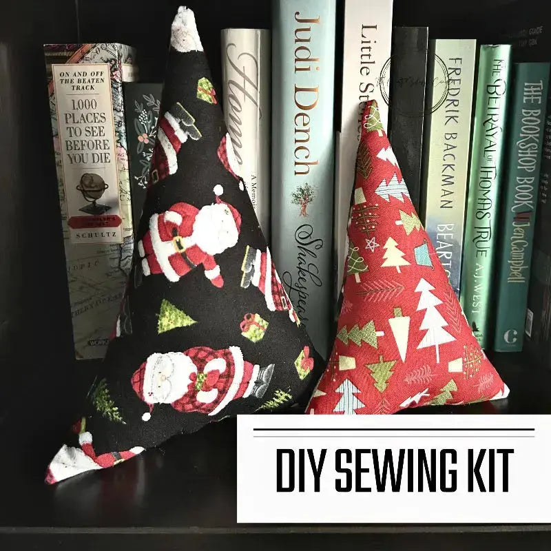 A DIY sewing kit for a set of 2 Christmas trees. The 2 finished trees are sitting on a bookshelf.