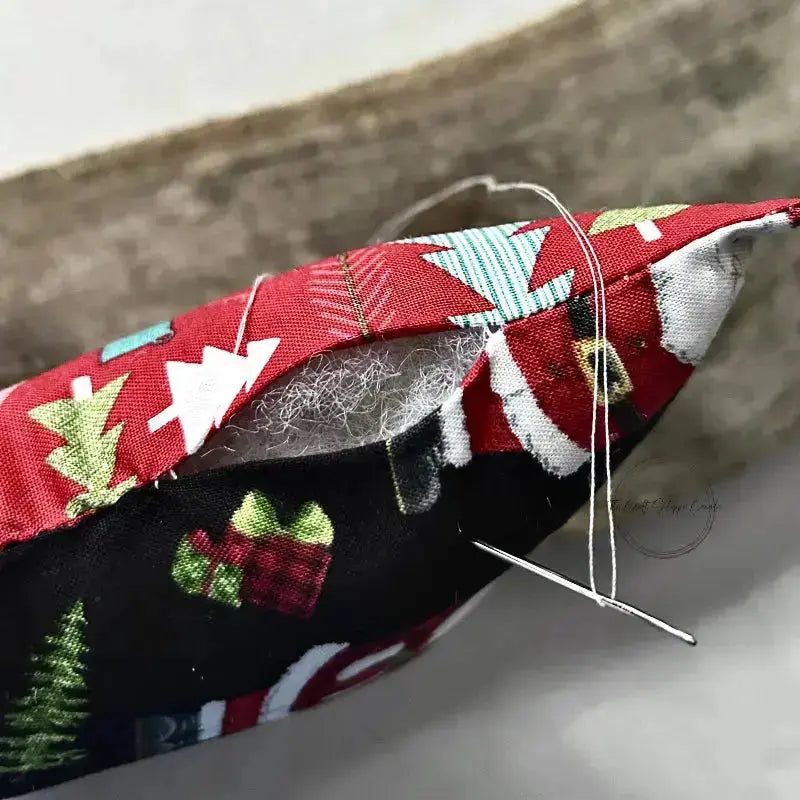 A close up of the bottom of the tree, made from this sewing pattern, to show the stuffing inside with a tapestry needle closing up the top.