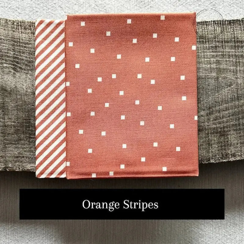 Fabric options for this sewing kit featuring an orange stripe pattern.