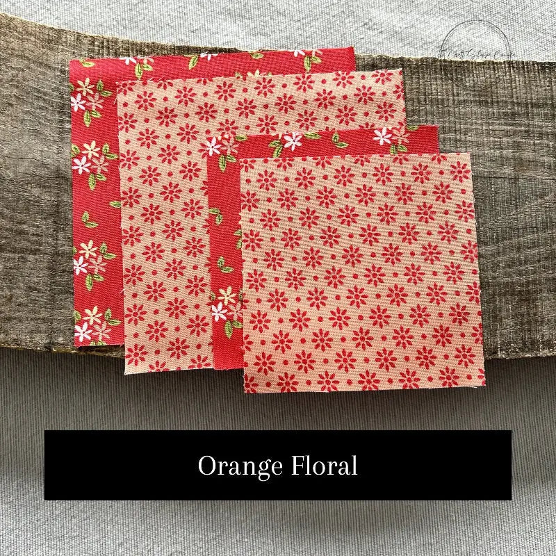 Fabric options for this sewing kit featuring a floral pattern of orange and peach colours.