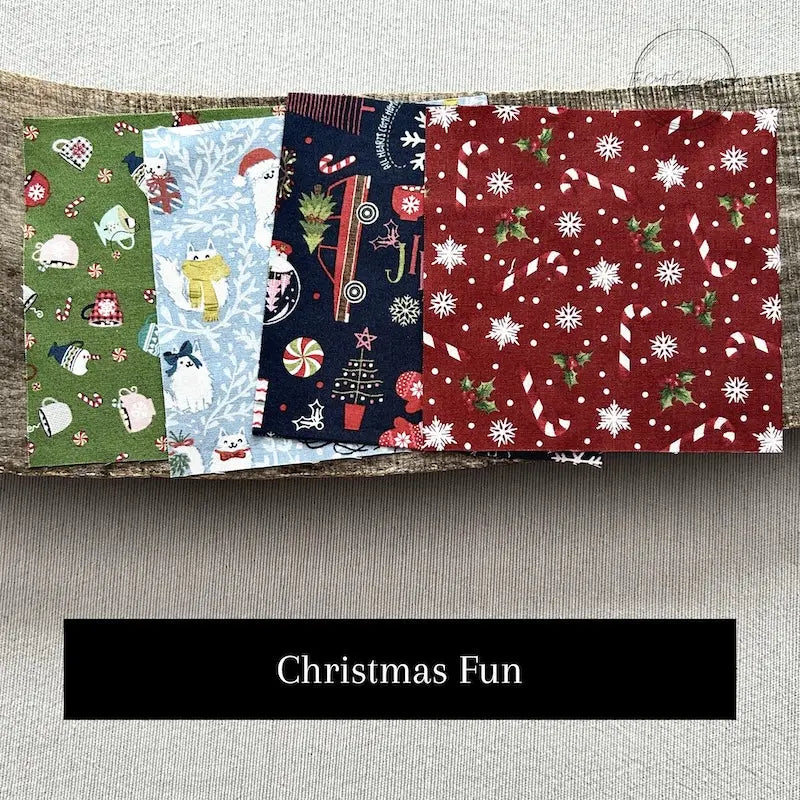 Fabric options for this sewing kit featuring a Christmas pattern of blue, green and red colours.