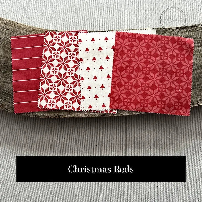 Fabric options for this sewing kit featuring a Christmas pattern of blue, green and red colours.