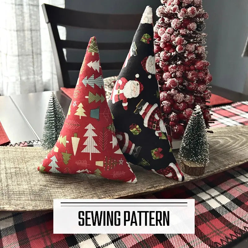 A digital PDF sewing pattern for a set of 2 Christmas trees. The 2 trees are sitting on a wooden board.