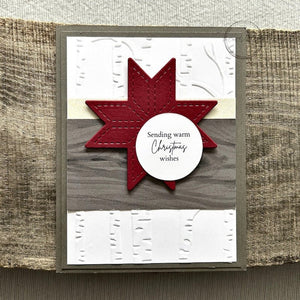 A finished card, from this DIY card kit, sitting on a wooden board.  - The Craft Shoppe Canada