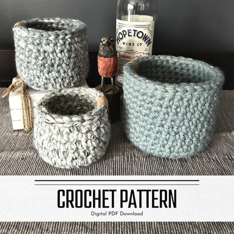 A digital crochet pattern for a set of 3 crocheted baskets. The baskets are sitting on top of a buffet - The Craft Shoppe Canada