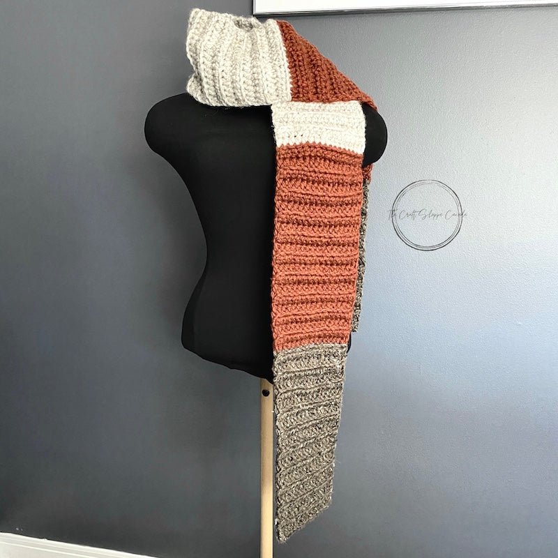 The finished scarf is hanging over a black dress form - The Craft Shoppe Canada
