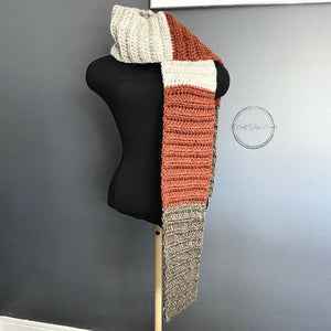 The finished scarf is hanging to feature the ivory, brown and orange colours. This scarf is the finished project for this digital crochet pattern - The Craft Shoppe Canada