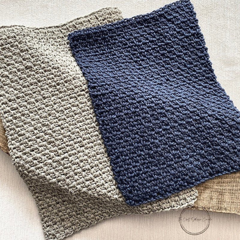 A close up of the finished grey and navy washcloths using the moss stitch - The Craft Shoppe Canada