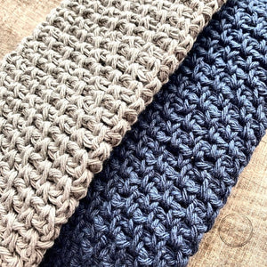 This is a photo of the finished washcloths. One is navy and one is grey and they both use the moss stitch - The Craft Shoppe Canada