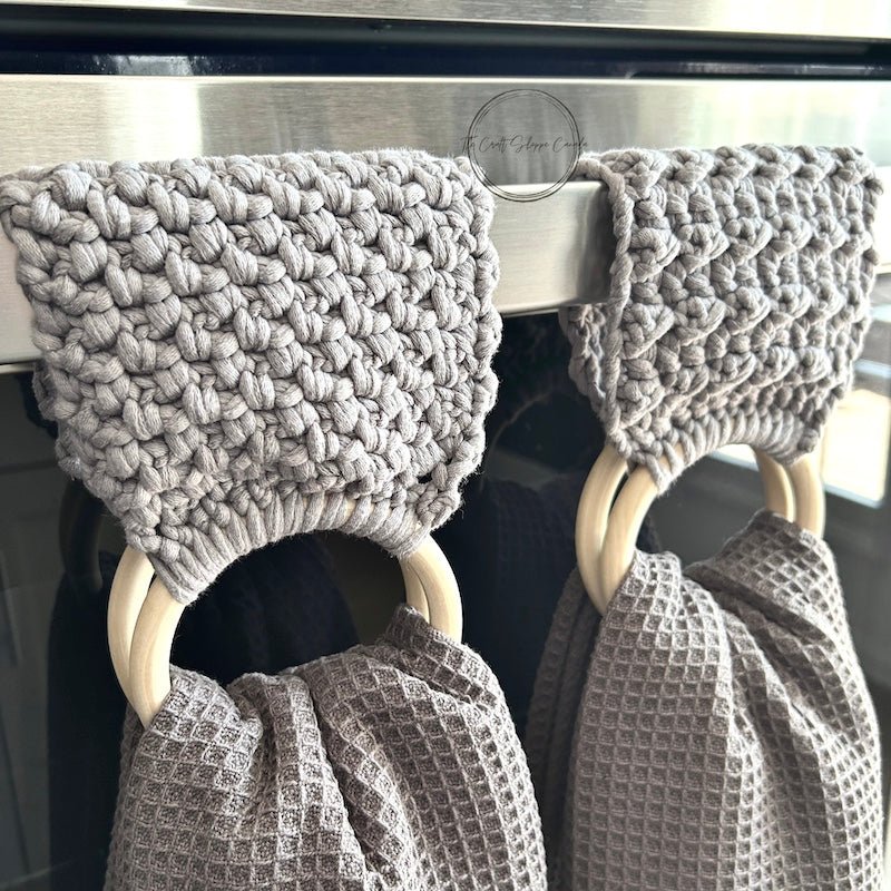 This is a photo of the finished towel holders hanging over a stove bar with towels - The Craft Shoppe Canada