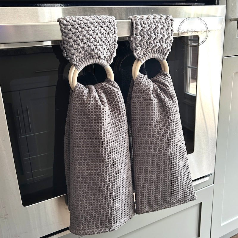 This is a photo of the finished towel holders hanging over a stove bar with towels - The Craft Shoppe Canada