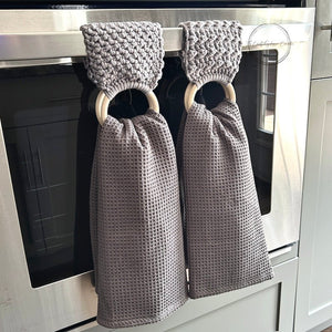 The finished towel holders hanging over a stove bar with towels - The Craft Shoppe Canada