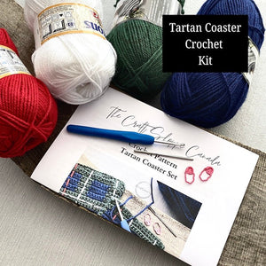 This is a complete crochet kit that includes yarn, a crochet hook, a tapestry needle, stitch markers and the pattern for a crochet Scottish tartan coaster set - The Craft Shoppe Canada