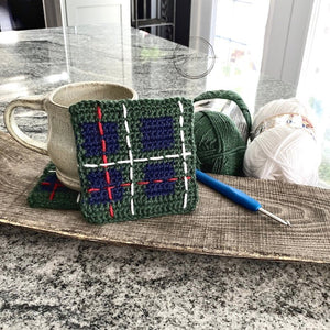 This photo shows the completed coasters along with the yarn that was used and a crochet hook - The Craft Shoppe Canada