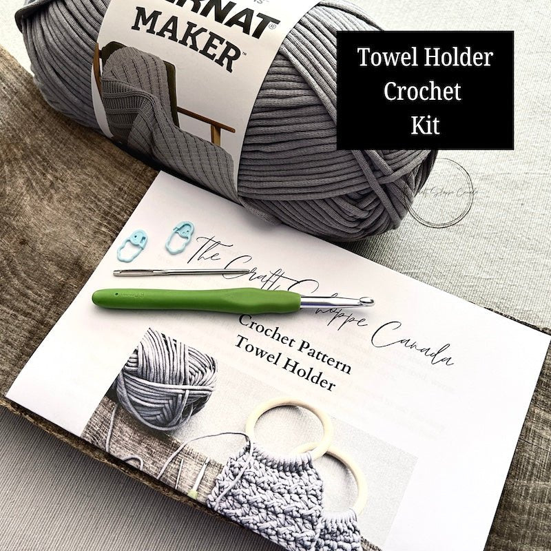 This is a complete crochet kit that includes yarn, a crochet hook, a tapestry needle, stitch markers and the pattern for a crochet towel holder - The Craft Shoppe Canada