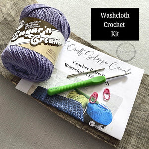 This is a complete crochet kit that includes yarn, a crochet hook, a tapestry needle, stitch markers and the pattern for a crochet washcloth dishcloth set - The Craft Shoppe Canada