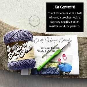 This photo lists the contents of the kit including the pattern, yarn, the optional crochet hook, a tapestry needle, and stitch markers - The Craft Shoppe Canada